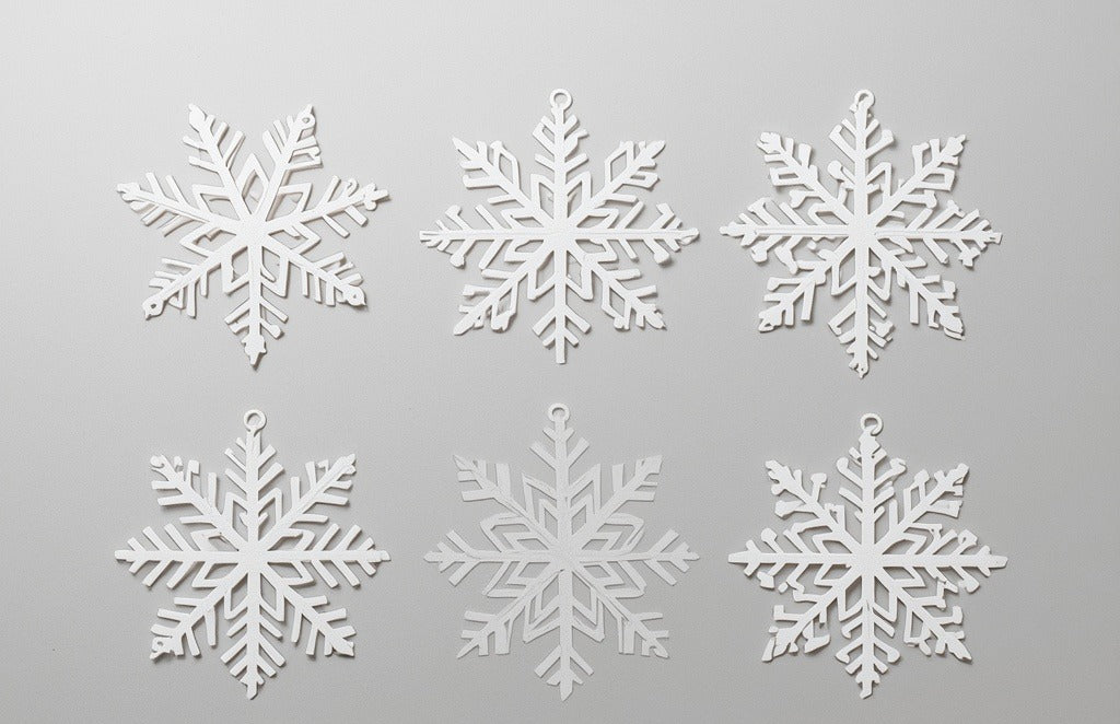 Seis copos de nieve blancos impresos en 3D en PLA para colgar del árbol. Imagen ilustrativa generada con IA; la pieza real impresa puede variar ligeramente.
